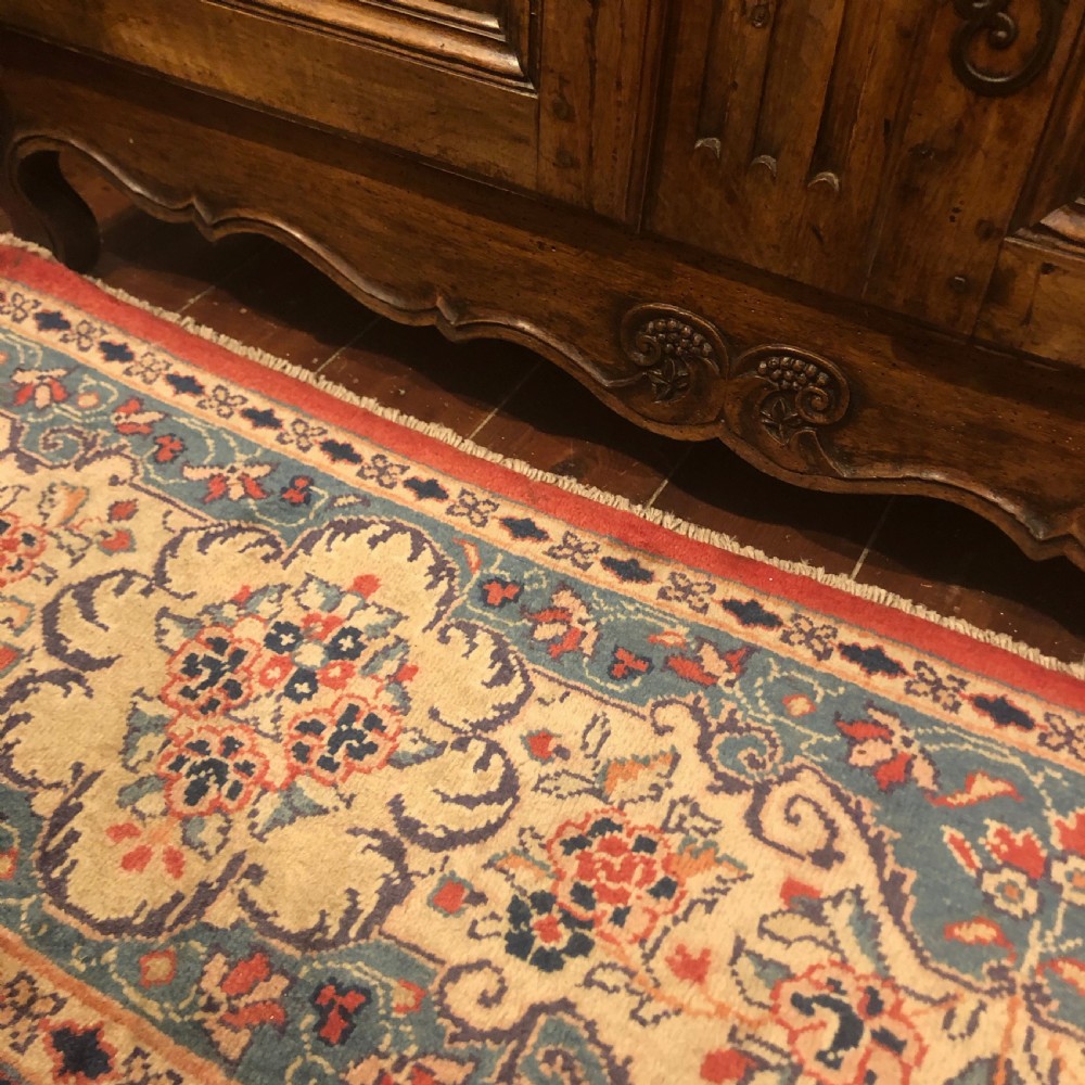 An 18th-century French provincial walnut buffet cabinet featuring a wide top drawer over two carved panelled doors with iron escutcheons and a shaped apron. View VI