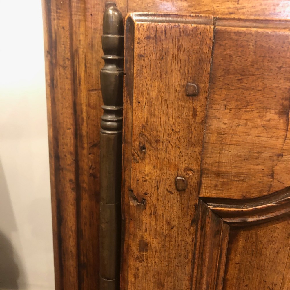 An 18th-century French provincial walnut buffet cabinet featuring a wide top drawer over two carved panelled doors with iron escutcheons and a shaped apron. View VII