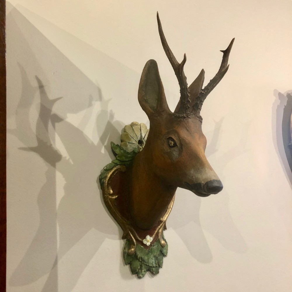 A late 19th-century Swedish hand-painted carved wood deer head with natural antlers mounted on an ornate heart-shaped plaque decorated with foliage motifs. View VI