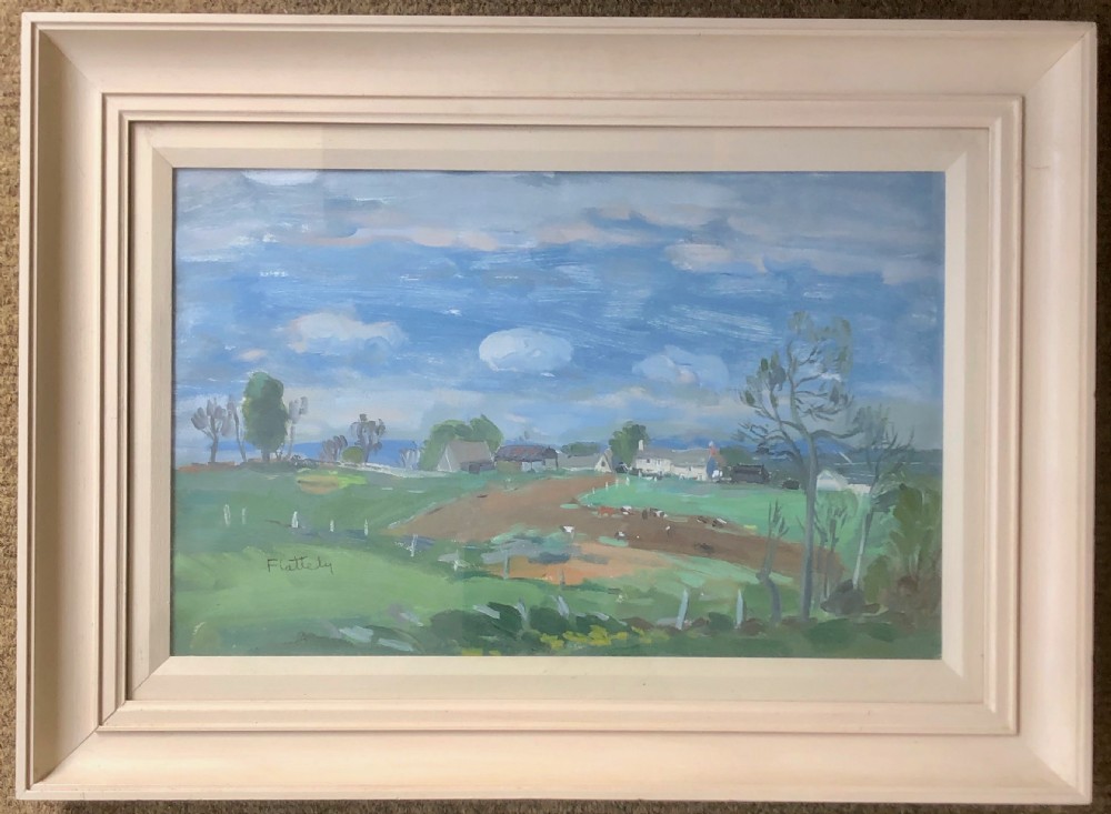 A framed mid-century landscape painting depicting green rural fields and farm buildings beneath a blue, cloudy sky.