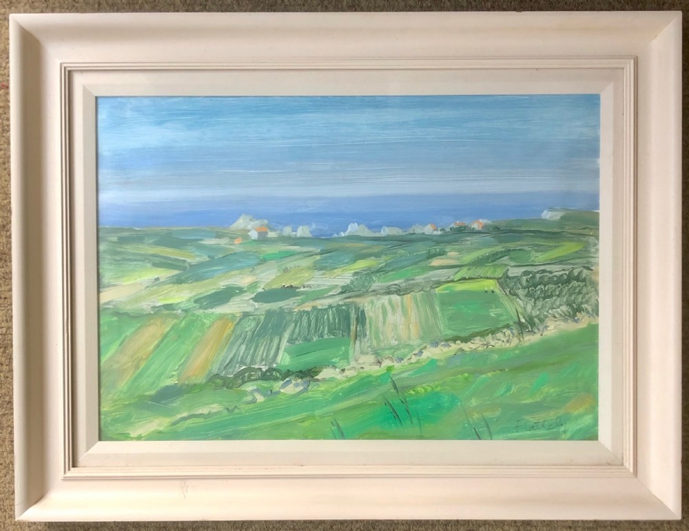 A framed horizontal landscape painting depicting green fields leading towards a blue ocean under a pale sky.