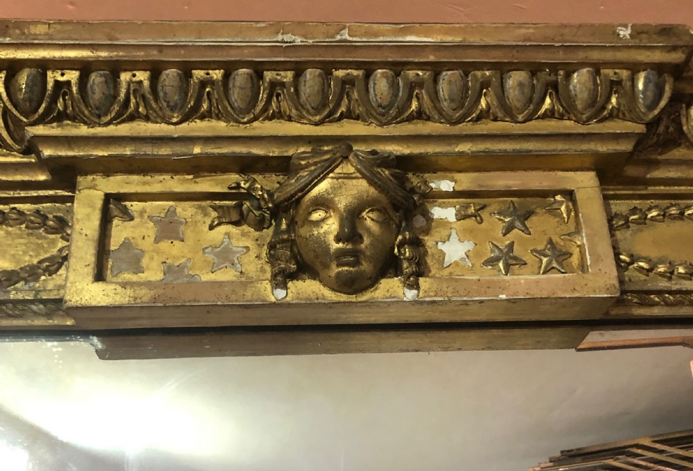 A large Adam Revival giltwood wall mirror featuring an arched top, classical moulding, and guilloche carving. View II
