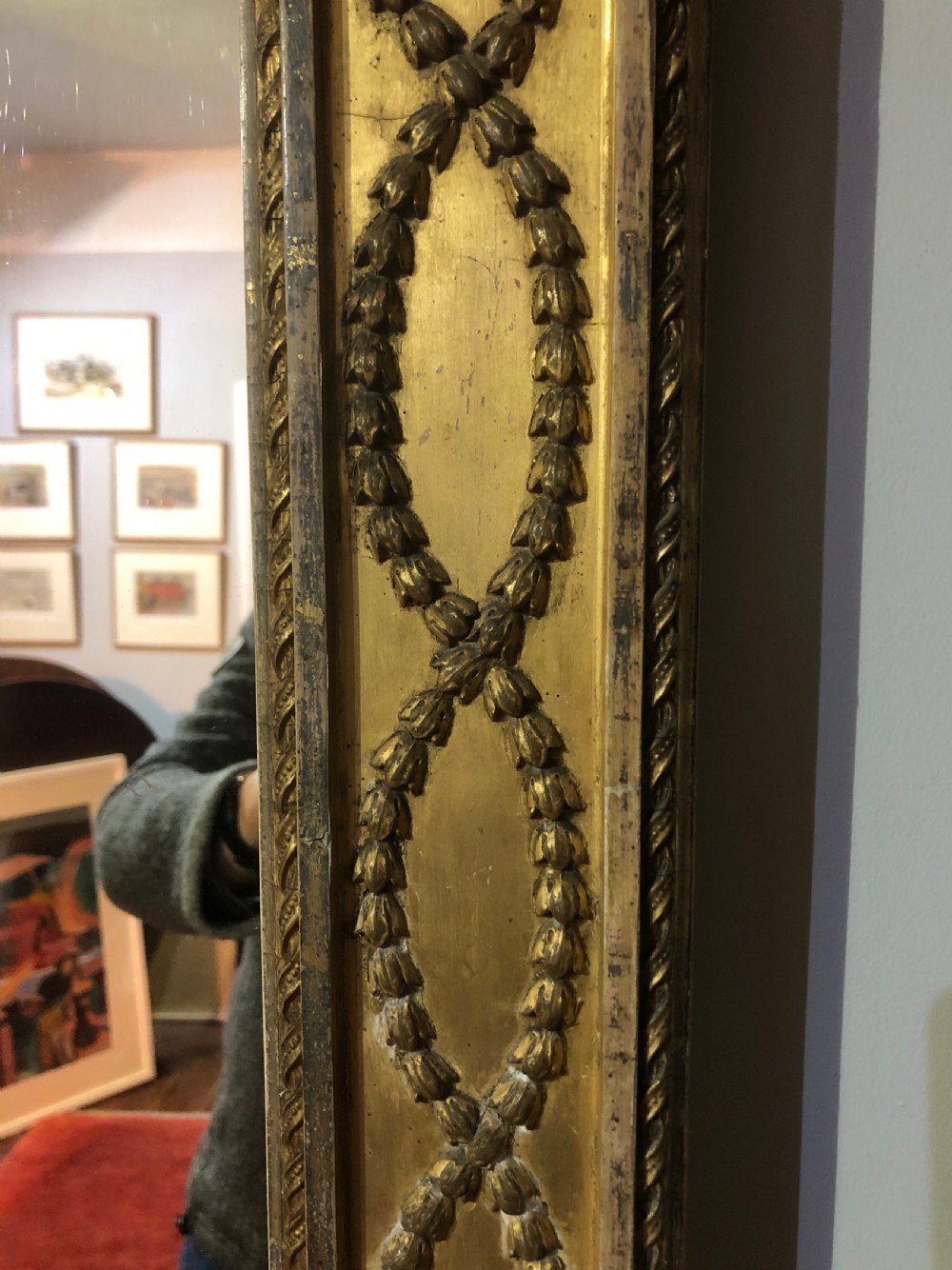 A large Adam Revival giltwood wall mirror featuring an arched top, classical moulding, and guilloche carving. View IV