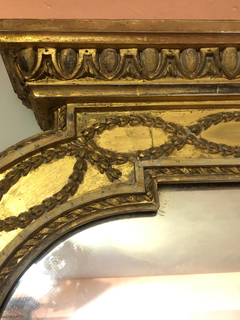 A large Adam Revival giltwood wall mirror featuring an arched top, classical moulding, and guilloche carving. View VII