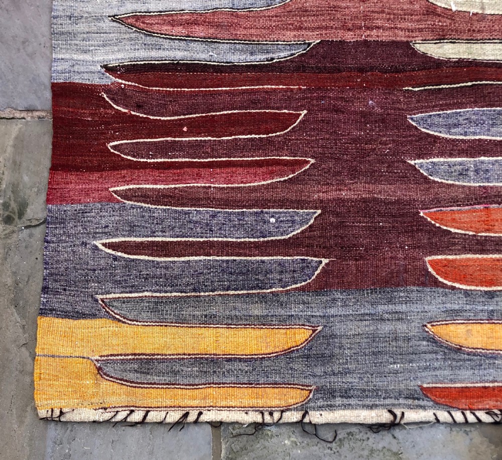 A flatwoven Turkish Afyon kelim rug featuring a central finger motif in shades of terracotta, maroon, grey, orange, and yellow. View IV