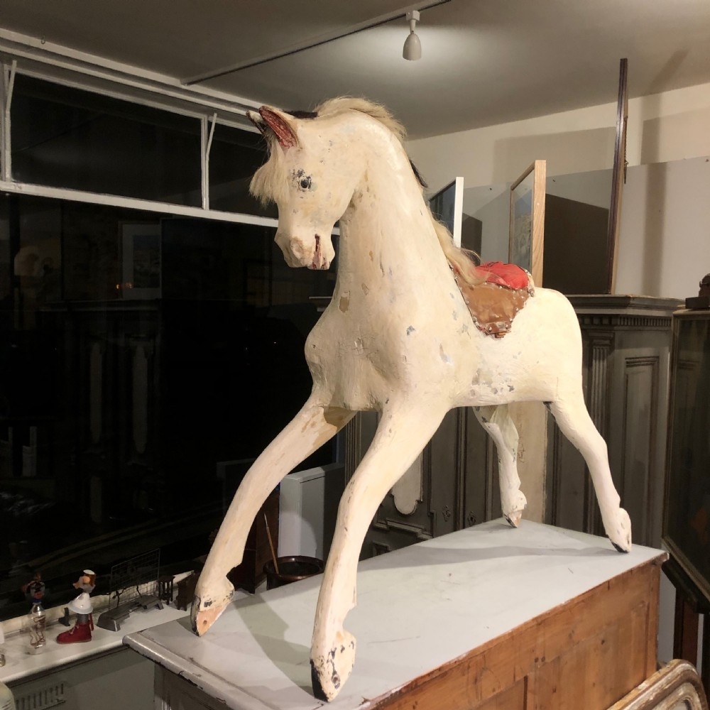 LARGE CARVED WOODEN ROCKING HORSE.