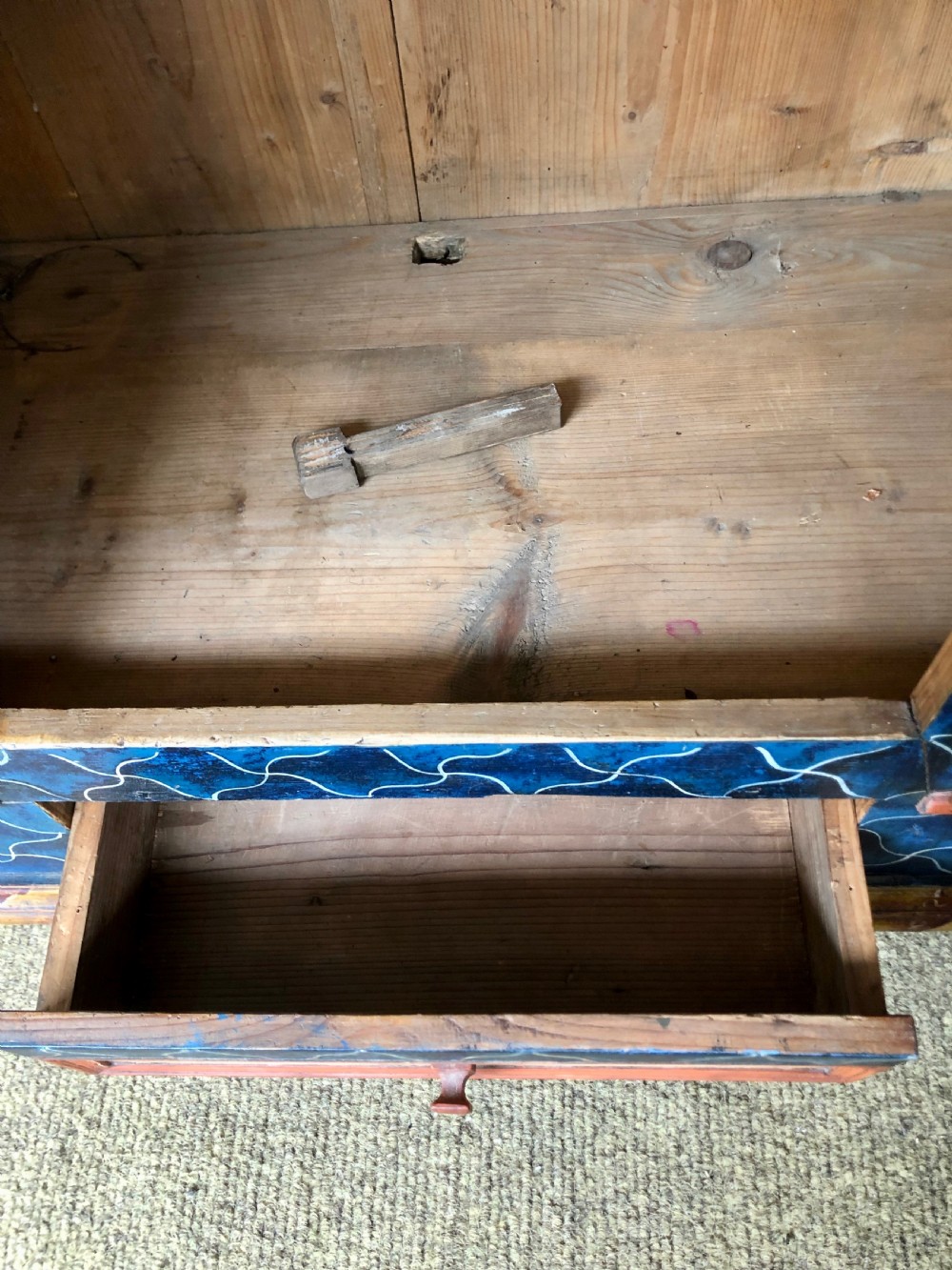 An Austro-Hungarian painted pine marriage armoire featuring a blue ground with geometric lattice motifs, hand-painted floral panels, and a shaped top cornice. View XII