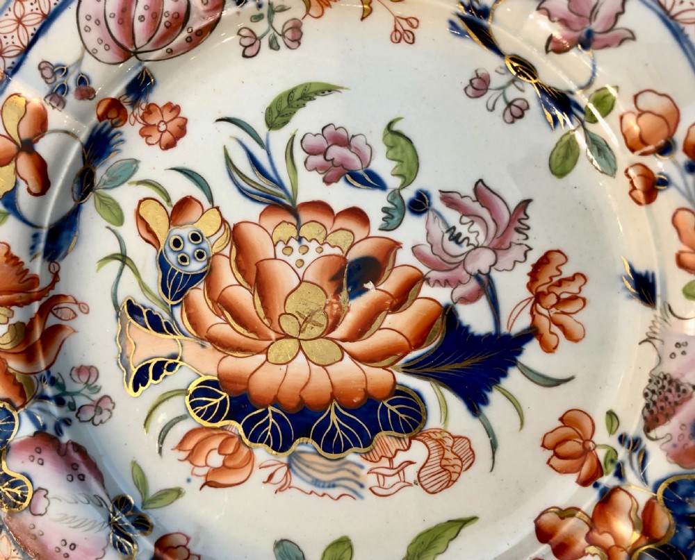 An antique Masons Patent Ironstone plate featuring hand-painted floral motifs in iron red and cobalt blue with a scalloped gilded rim. View II