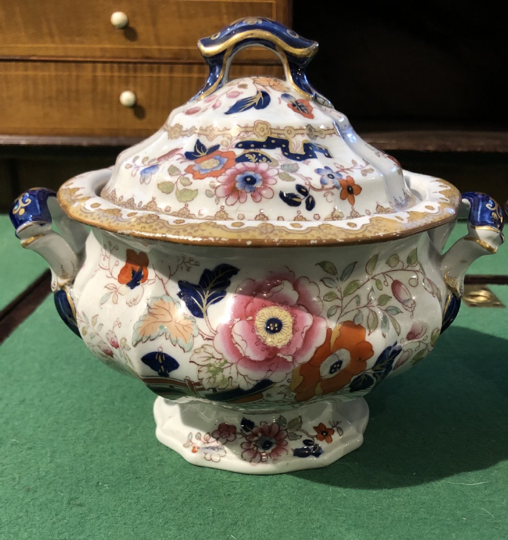 A pair of 19th-century ironstone ceramic tureens with lids, featuring floral hand-painted enamel motifs, cobalt blue handles, and gilt trim. View II
