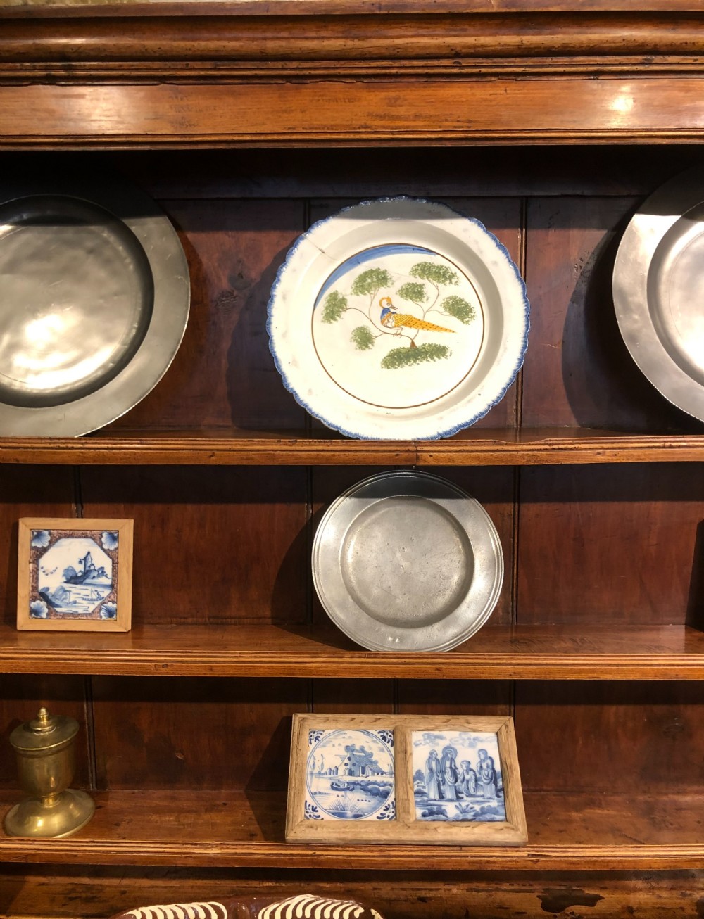 An 18th-century English elm dresser with a three-shelf plate rack, lower drawers with brass handles, and two panelled cupboard doors. View VII
