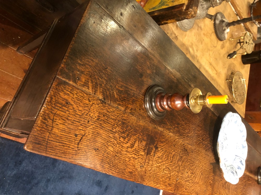An 18th-century dark oak dresser base featuring three brass-handled drawers supported on slender cabriole legs. View IV