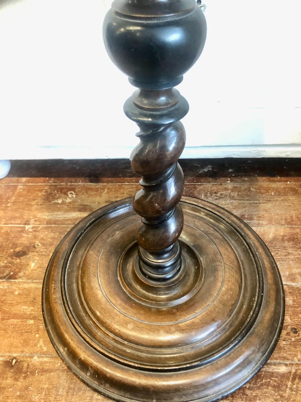 An 18th-century Georgian mahogany pedestal featuring a barley twist column, ebonised turnings, and a heavy circular moulded base. View VII