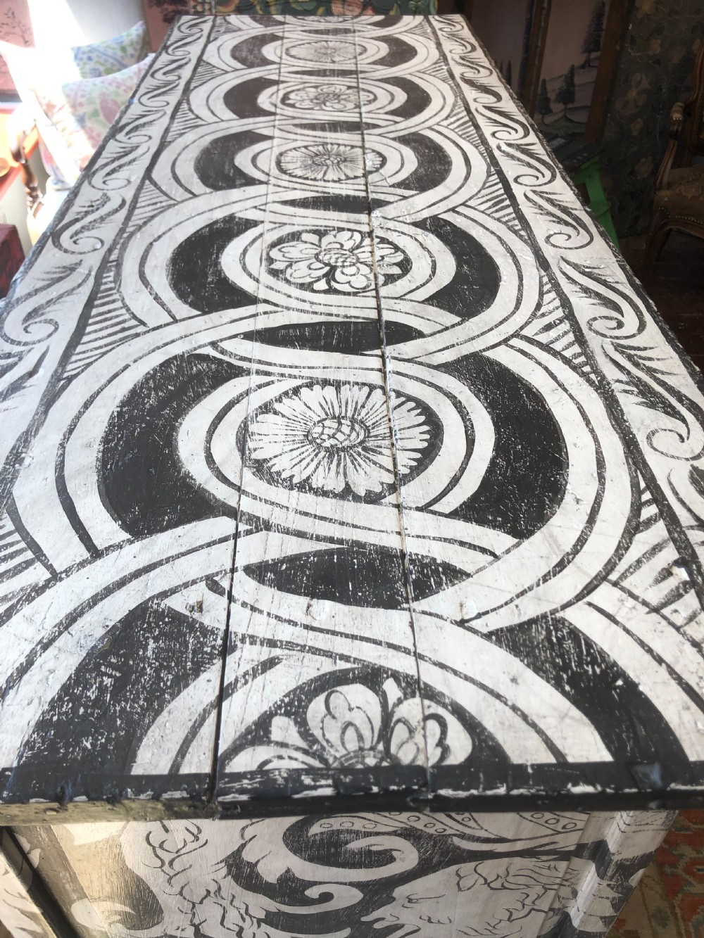A two-door wooden French buffet cabinet hand-painted with black and white grotesque foliate scrollwork and human figures. View IX