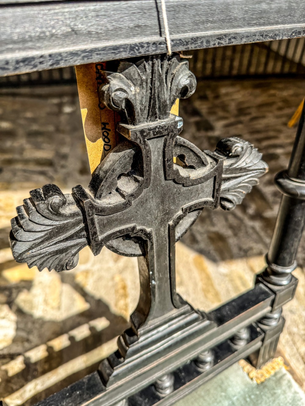 A 19th-century ebonised wood prie-dieu prayer chair featuring a carved central cross, turned upright spindles, and sage green velvet upholstery on the kneeling seat and top rail. View IV