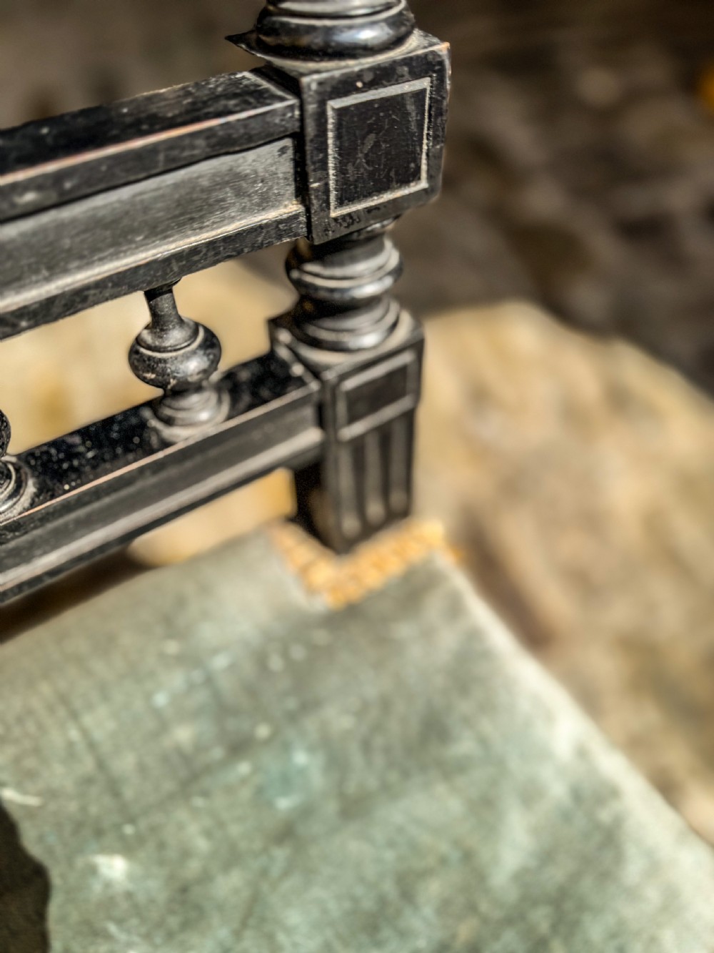 A 19th-century ebonised wood prie-dieu prayer chair featuring a carved central cross, turned upright spindles, and sage green velvet upholstery on the kneeling seat and top rail. View VI