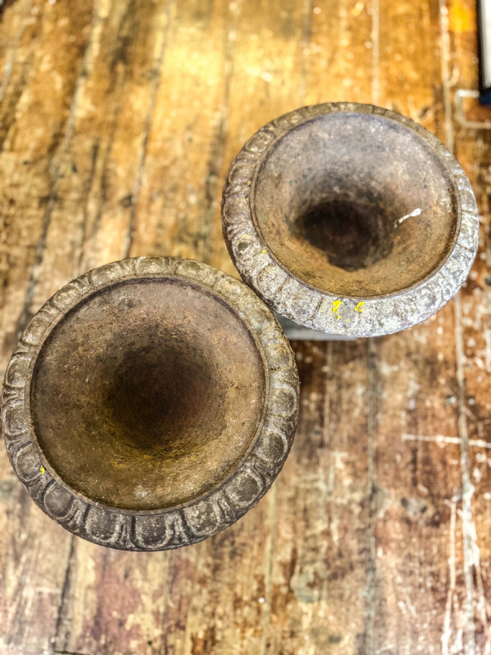 A pair of weathered Victorian cast iron garden urns featuring egg-and-dart moulded rims and square pedestal bases. View III