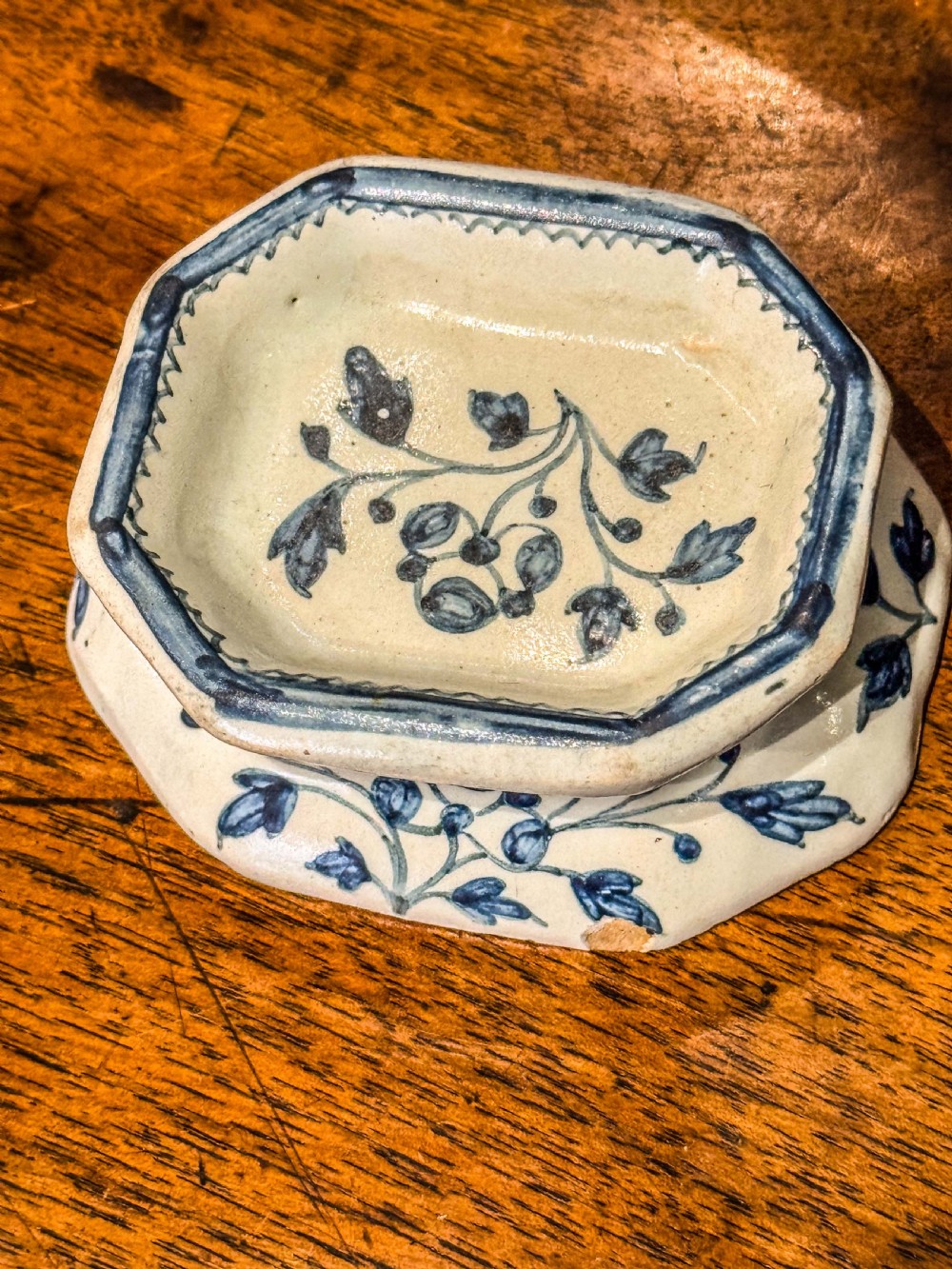 An eighteenth-century octagonal English Delftware salt cellar crafted from tin-glazed earthenware and decorated with hand-painted cobalt blue botanical patterns. View III
