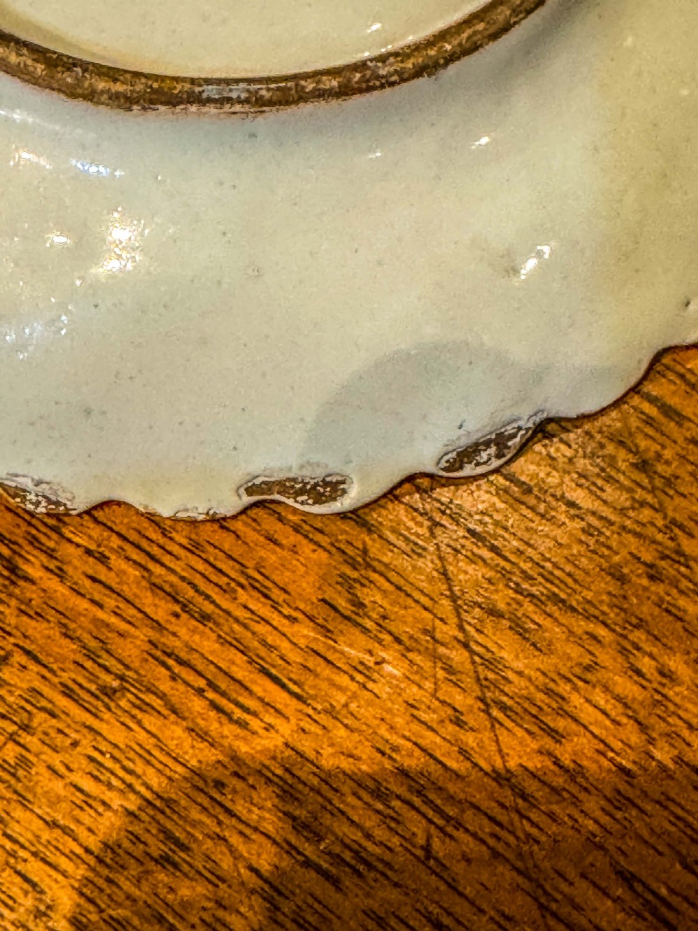 A nineteenth-century French blue and white faience shell-shaped vide-poche dish decorated with a central figure, floral sprigs, and a scalloped rim. View IV