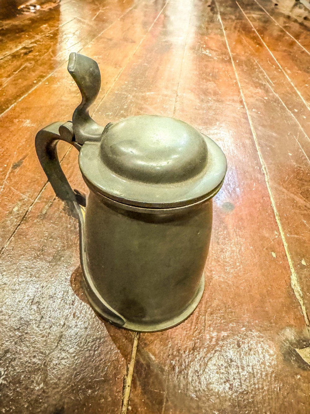 An antique lidded pewter tankard featuring a sinuous Art Nouveau handle and an oxidized dark grey finish. View II