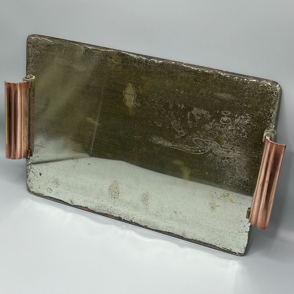 A rectangular Art Deco mirrored glass tray featuring cut decorative edges and rolled copper handles supported by small footings. View III