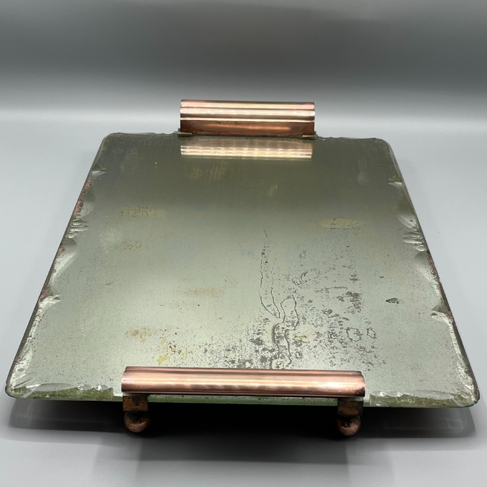 A rectangular Art Deco mirrored glass tray featuring cut decorative edges and rolled copper handles supported by small footings. View XIII