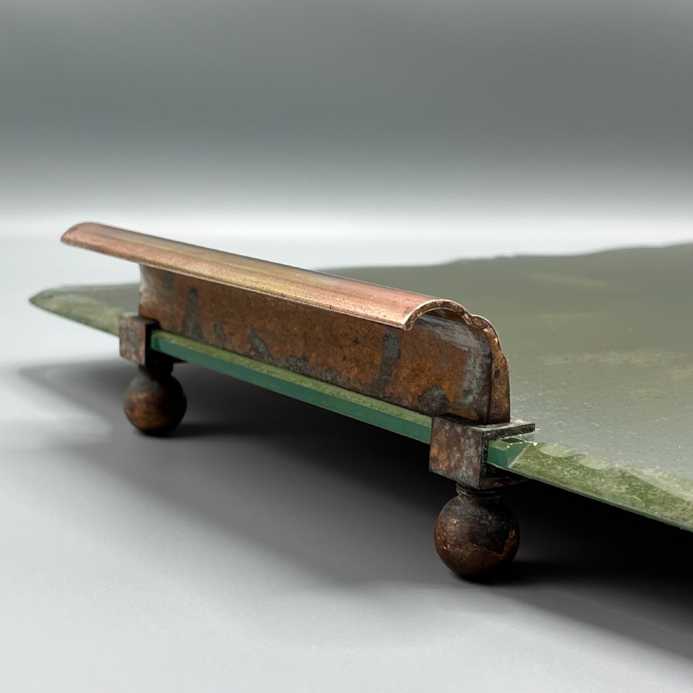 A rectangular Art Deco mirrored glass tray featuring cut decorative edges and rolled copper handles supported by small footings. View XIV