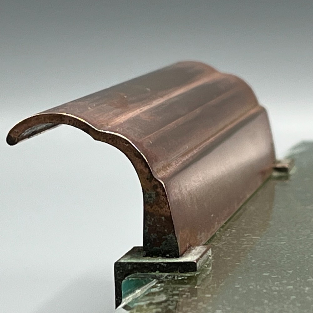A rectangular Art Deco mirrored glass tray featuring cut decorative edges and rolled copper handles supported by small footings. View XV