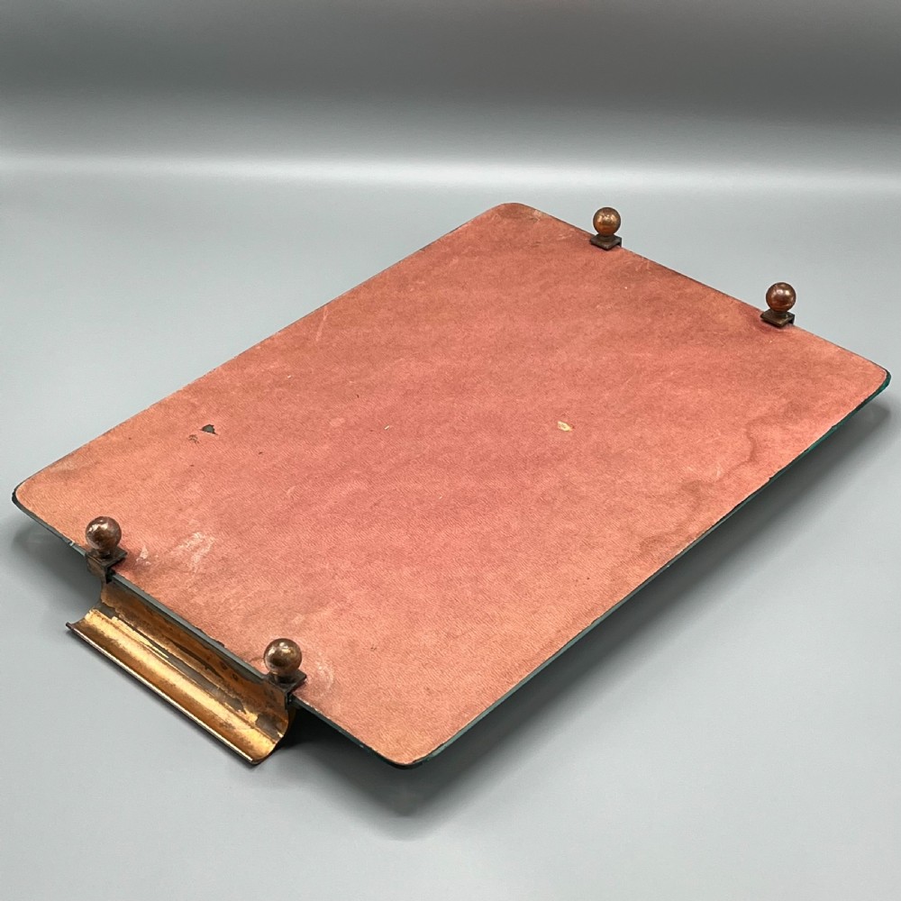 A rectangular Art Deco mirrored glass tray featuring cut decorative edges and rolled copper handles supported by small footings. View XVI
