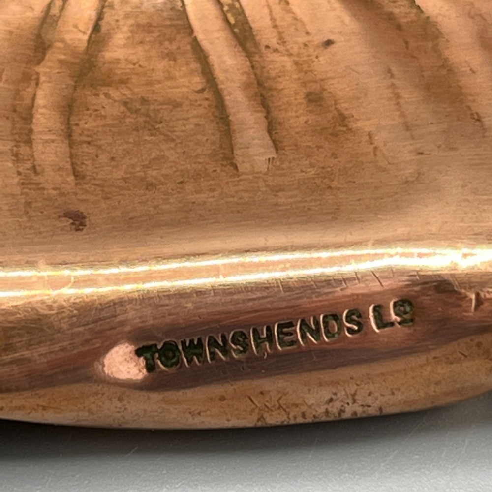 An oval Art Nouveau copper tray with hand-punched background texturing, scalloped edges, and embossed floral relief motifs. View XIV