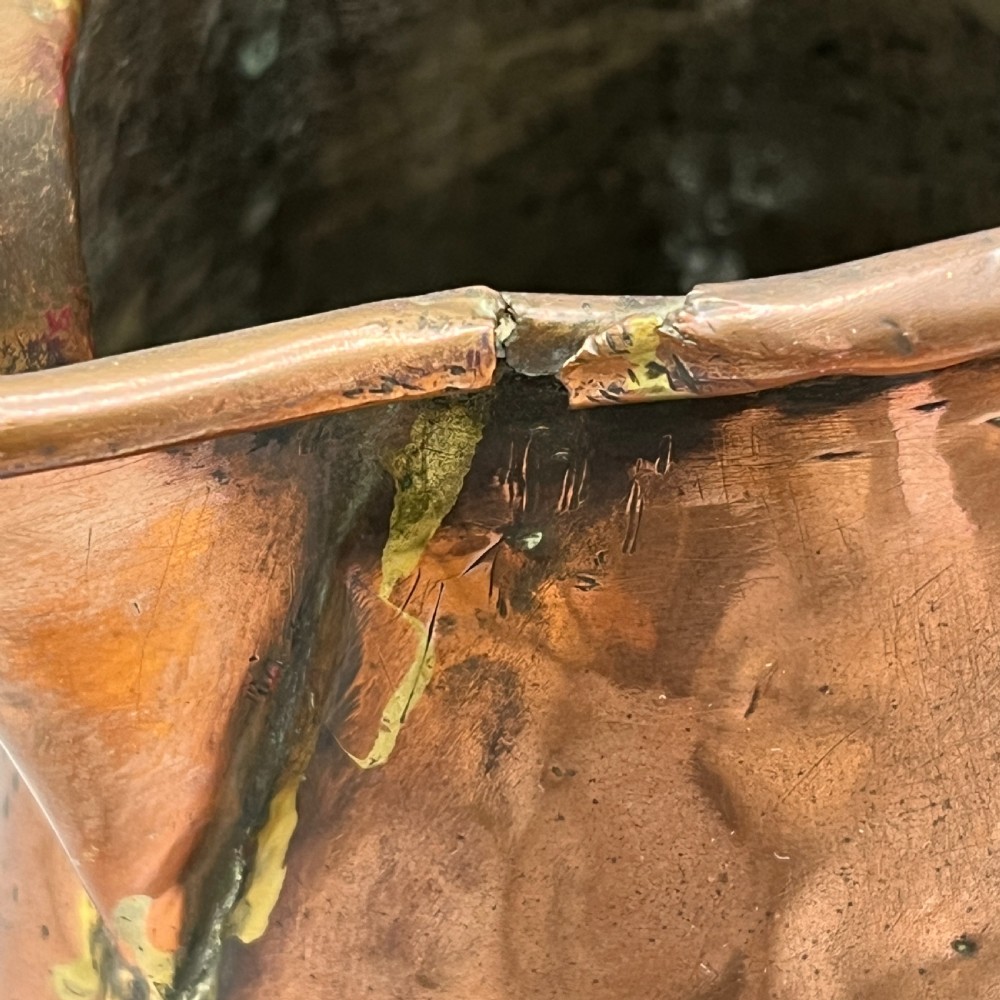 An antique Georgian copper jug featuring a hand-hammered body, wide pouring spout, flared base, and a riveted loop handle. View IX