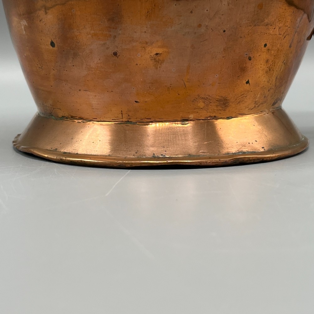 A Georgian copper jug featuring a bulbous body, a flared circular base, a pinched pouring spout, and a large curved loop handle. View XIII