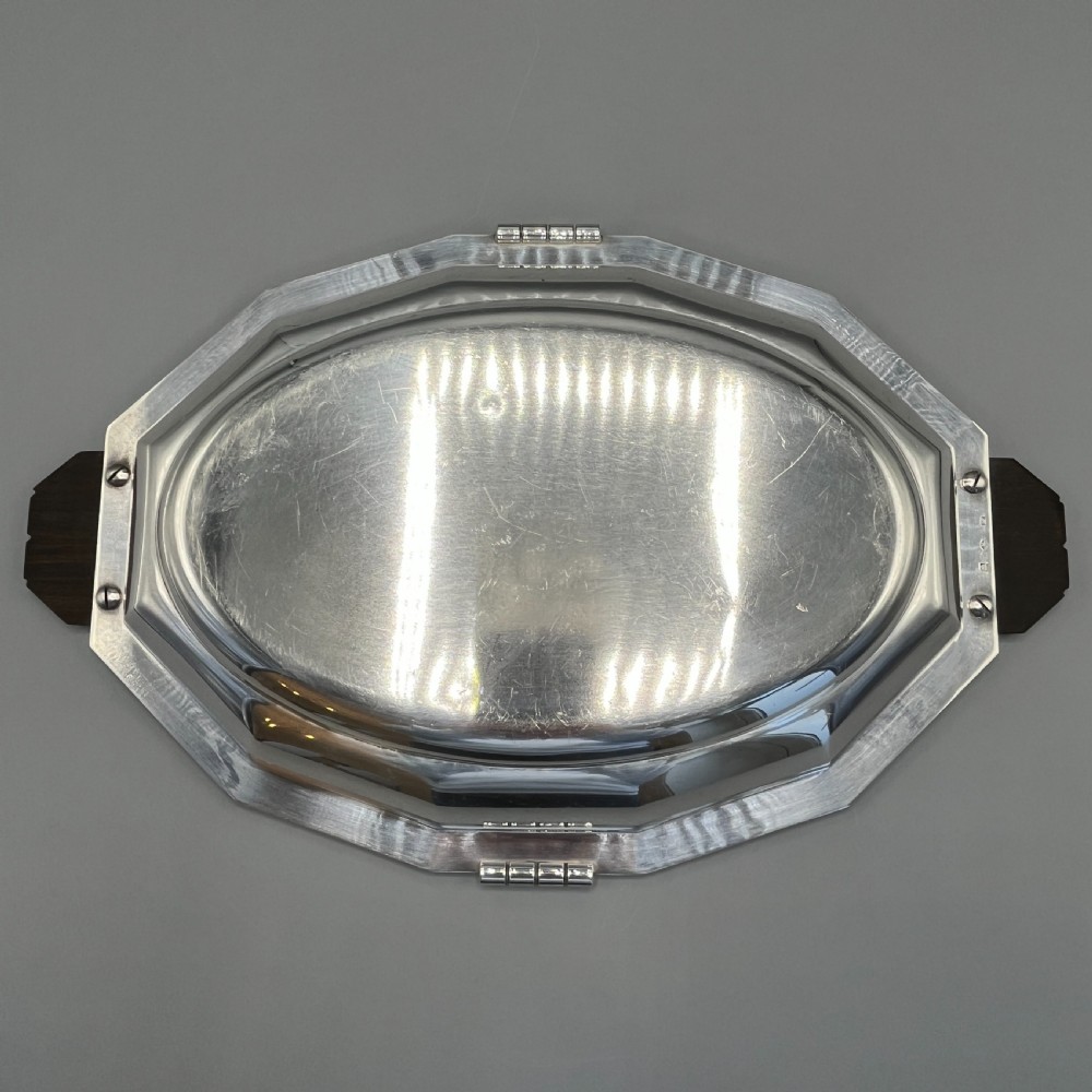 An octagonal silver-plated serving dish featuring faceted sides and carved dark wooden handles on opposite ends. View XI