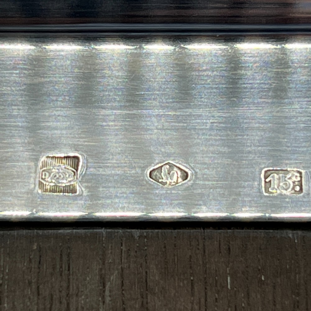 An octagonal silver-plated serving dish featuring faceted sides and carved dark wooden handles on opposite ends. View XII