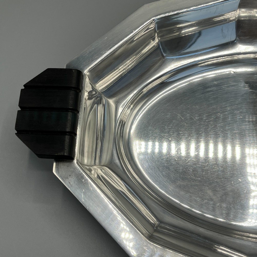 An octagonal silver-plated serving dish featuring faceted sides and carved dark wooden handles on opposite ends. View XIII