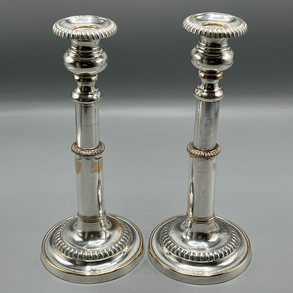 A pair of silver plated telescopic candlesticks featuring gadrooned borders and circular stepped bases. View III