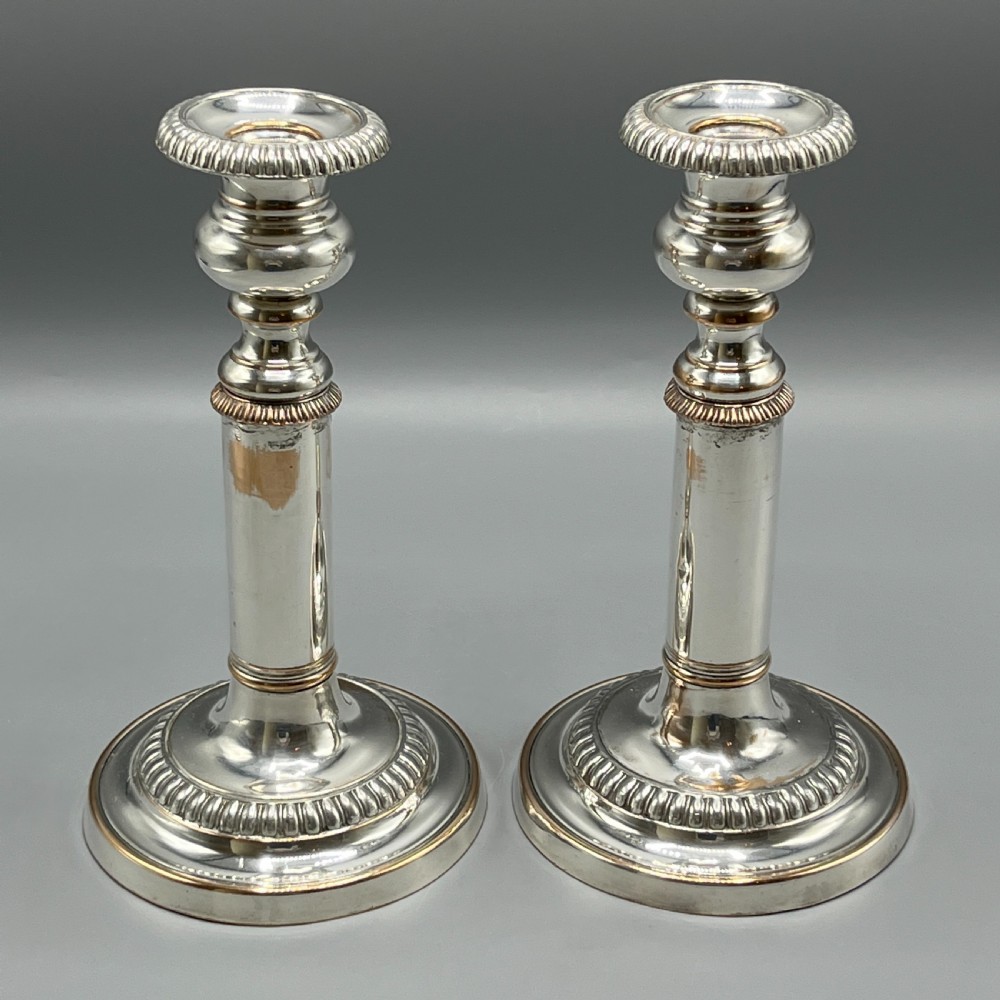 A pair of silver plated telescopic candlesticks featuring gadrooned borders and circular stepped bases. View VI