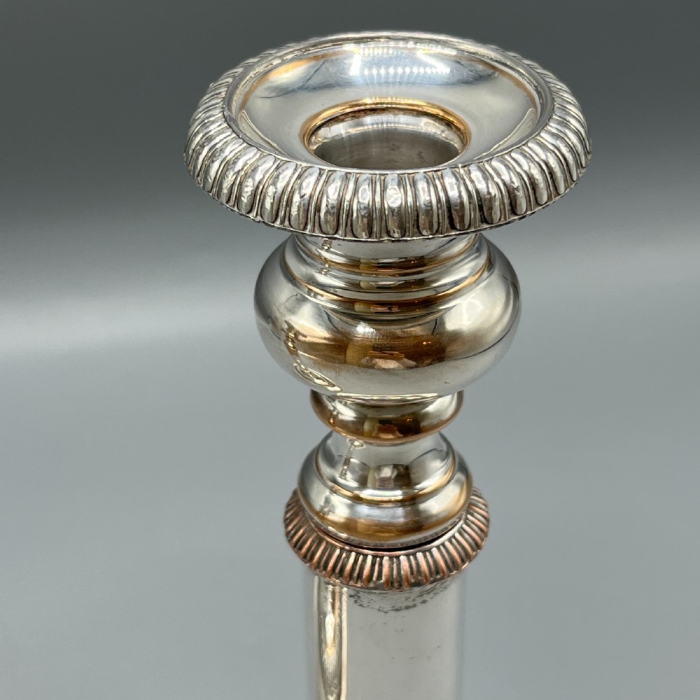A pair of silver plated telescopic candlesticks featuring gadrooned borders and circular stepped bases. View XII