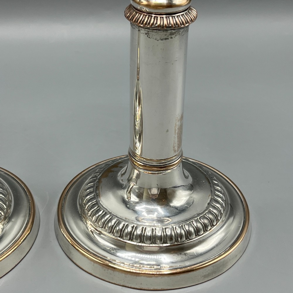 A pair of silver plated telescopic candlesticks featuring gadrooned borders and circular stepped bases. View XIII