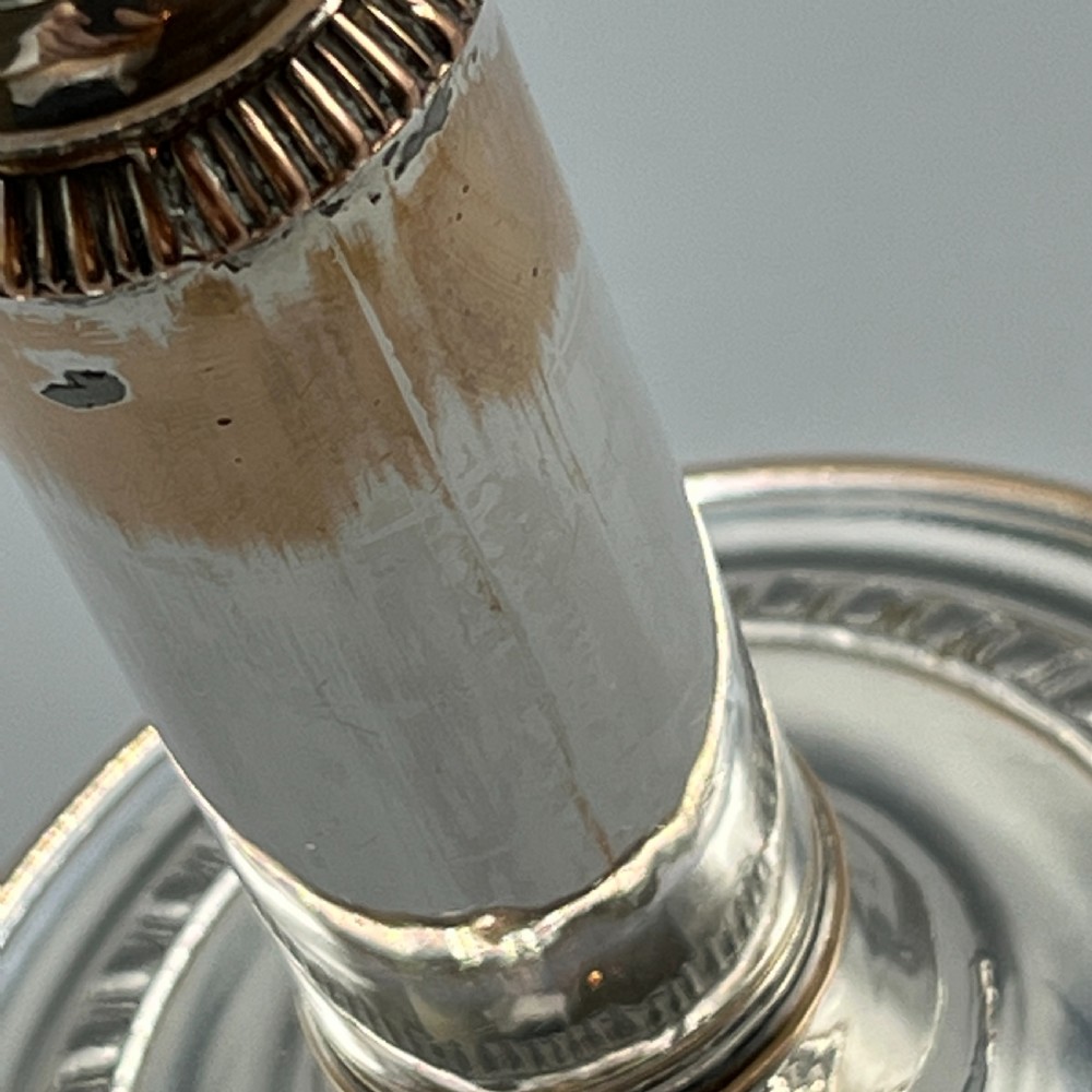 A pair of silver plated telescopic candlesticks featuring gadrooned borders and circular stepped bases. View XVI