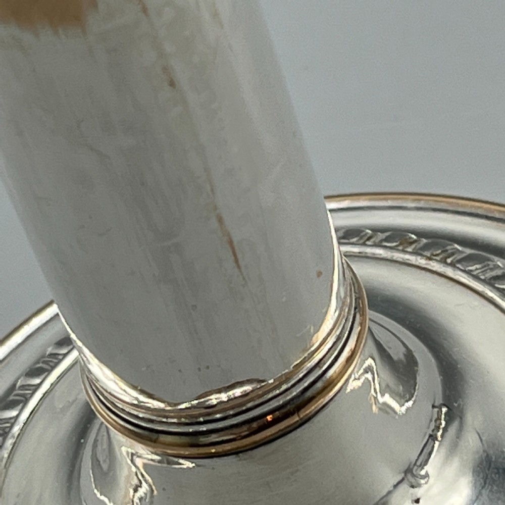 A pair of silver plated telescopic candlesticks featuring gadrooned borders and circular stepped bases. View XVII