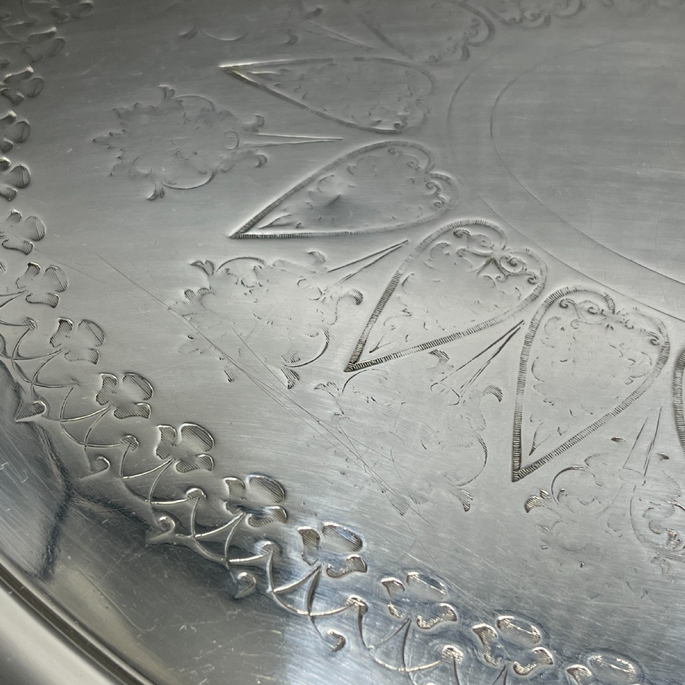 A large Victorian oval silver-plated serving tray featuring twin carrying handles, a textured rope border, and elaborate floral central engraving. View XIV