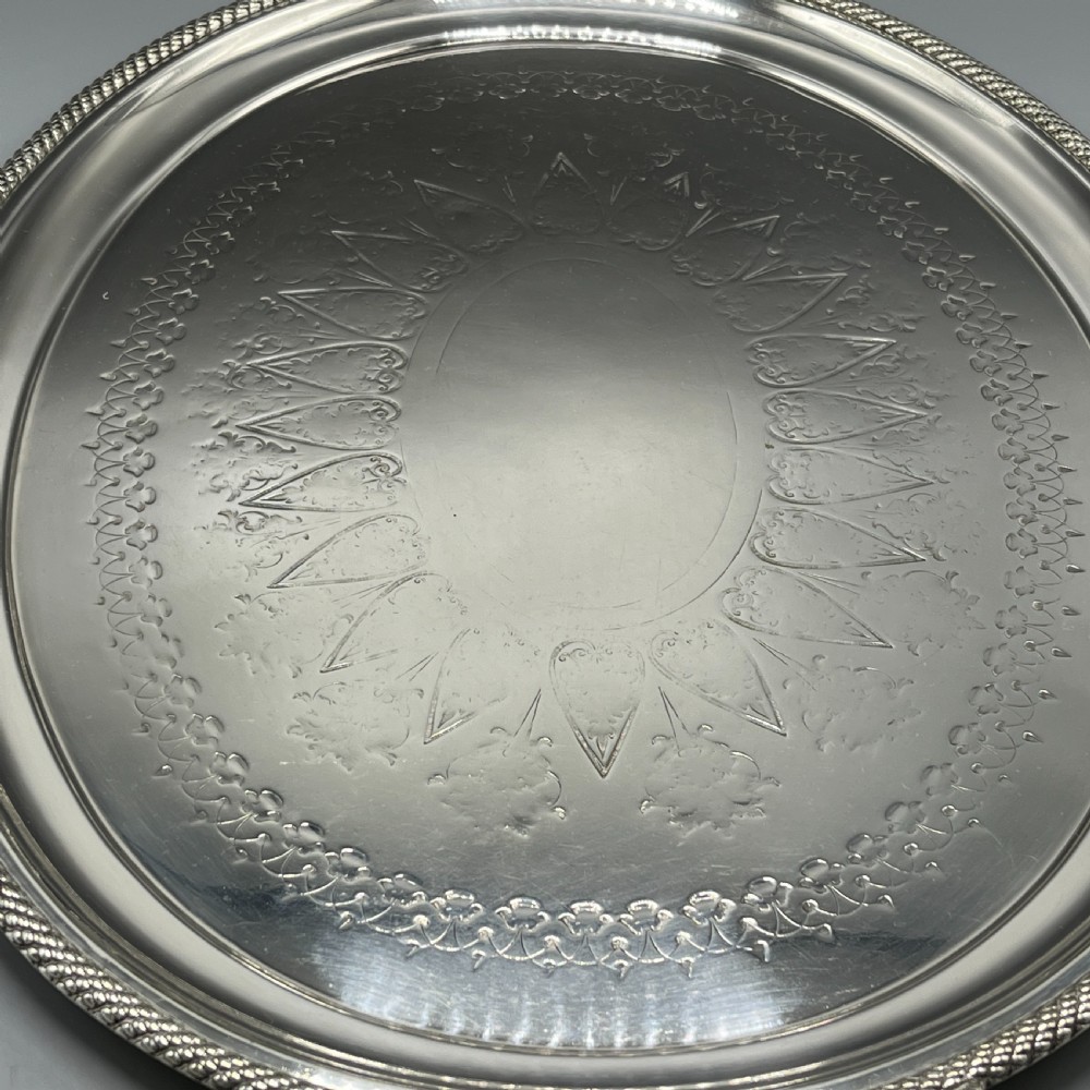 A large Victorian oval silver-plated serving tray featuring twin carrying handles, a textured rope border, and elaborate floral central engraving. View XVIII
