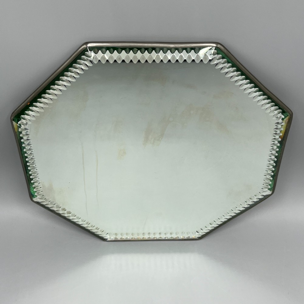 An octagonal frameless mirror featuring a decoratively cut bevelled interior border pattern on a clear mirrored surface. View II