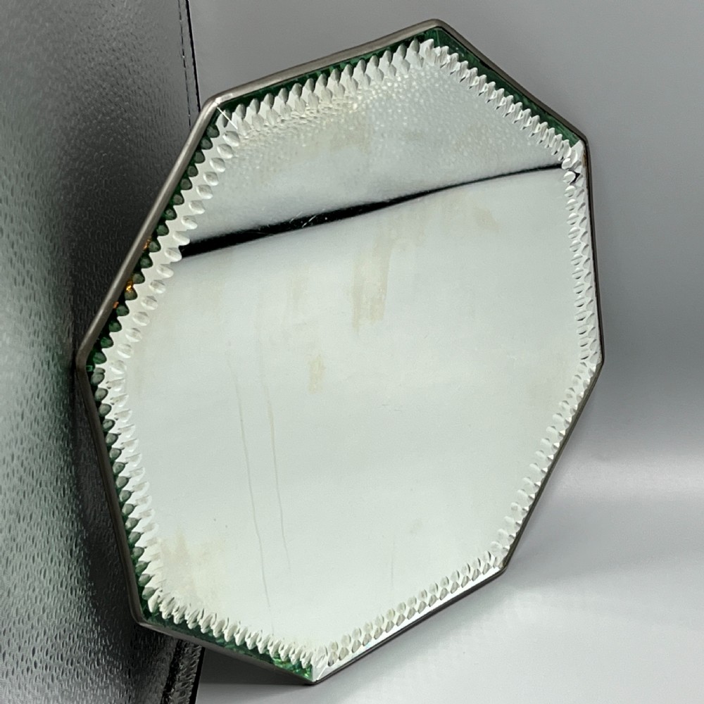 An octagonal frameless mirror featuring a decoratively cut bevelled interior border pattern on a clear mirrored surface. View IV