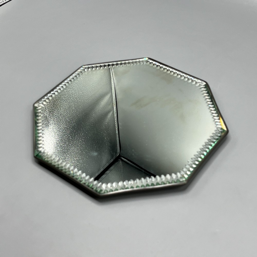 An octagonal frameless mirror featuring a decoratively cut bevelled interior border pattern on a clear mirrored surface. View VIII