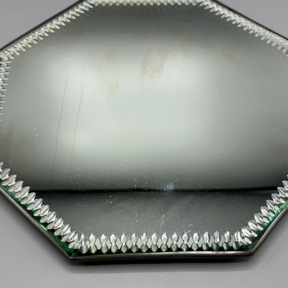 An octagonal frameless mirror featuring a decoratively cut bevelled interior border pattern on a clear mirrored surface. View XIII