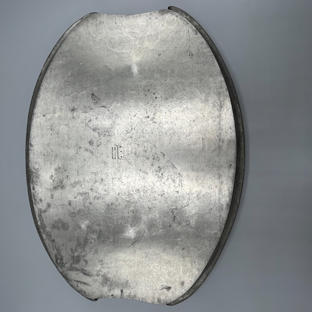 An oval pewter serving tray featuring a hand-hammered surface texture and raised integral handles on opposite ends. View XX