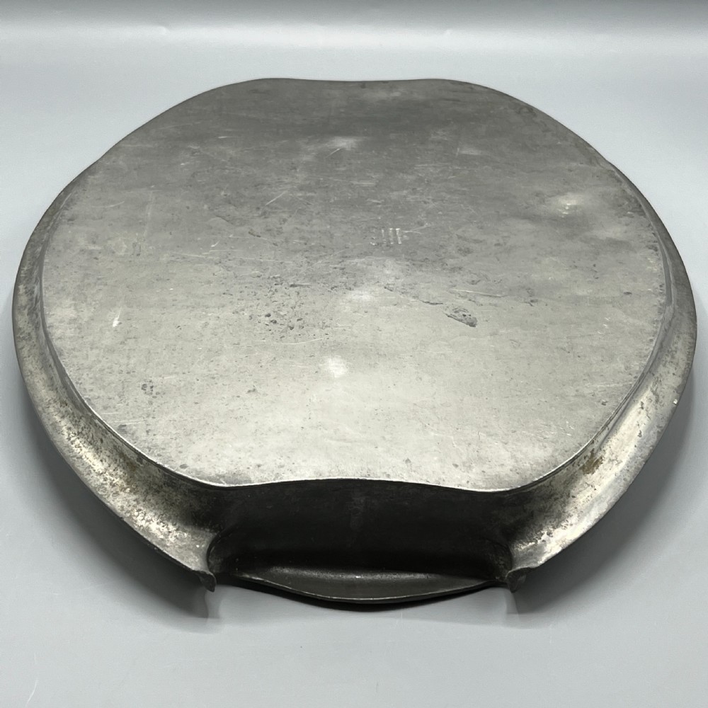 An oval pewter serving tray featuring a hand-hammered surface texture and raised integral handles on opposite ends. View XXIII