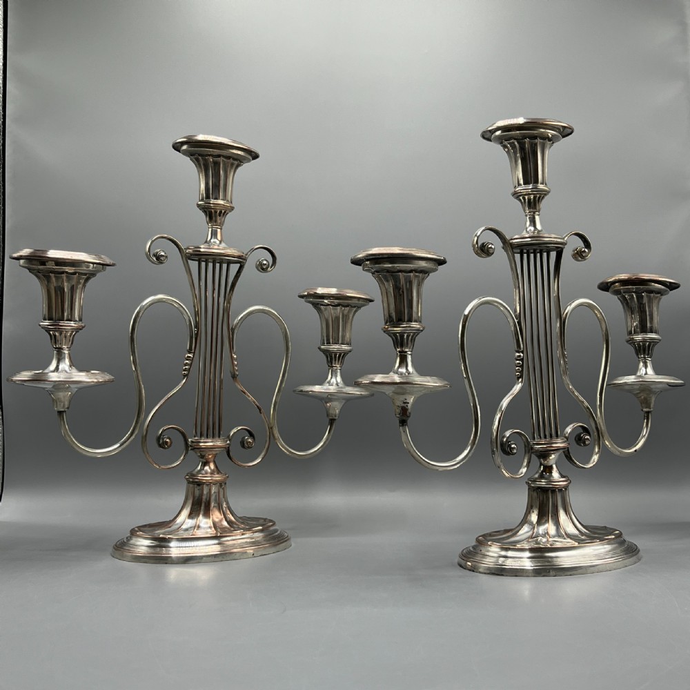 A pair of Georgian silver-plated three-light candelabra with lyre-shaped columns and scrolling branches. View II