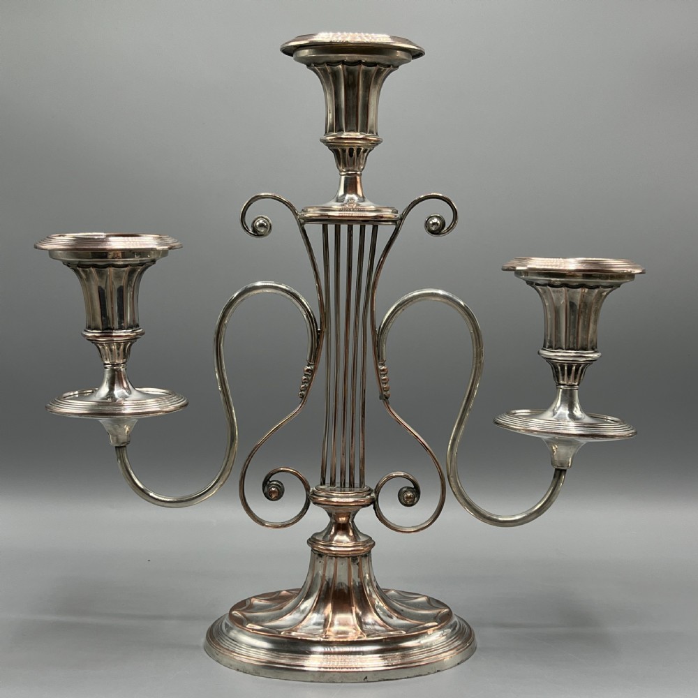 A pair of Georgian silver-plated three-light candelabra with lyre-shaped columns and scrolling branches. View X